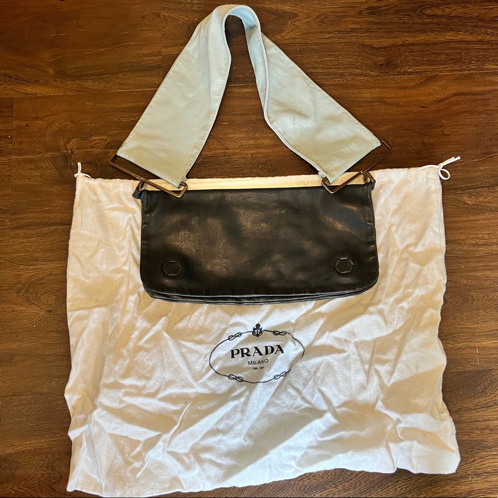 Prada, black leather bag with baby blue strap.